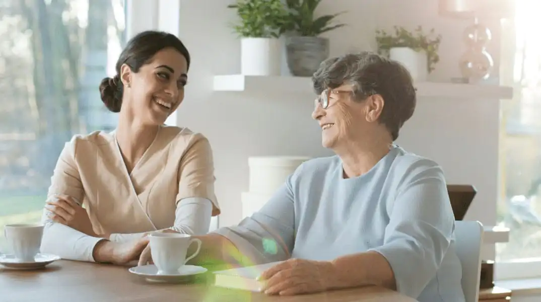 A Carer and an elderly lady having coffee