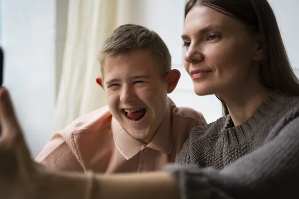 side-view-woman-boy-taking-selfie - Autism Awareness Training