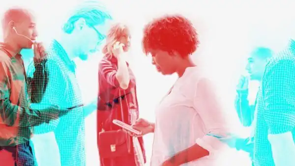 People using digital devices using a double colour exposure effect in red and blue. - Rapid Induction Training Course