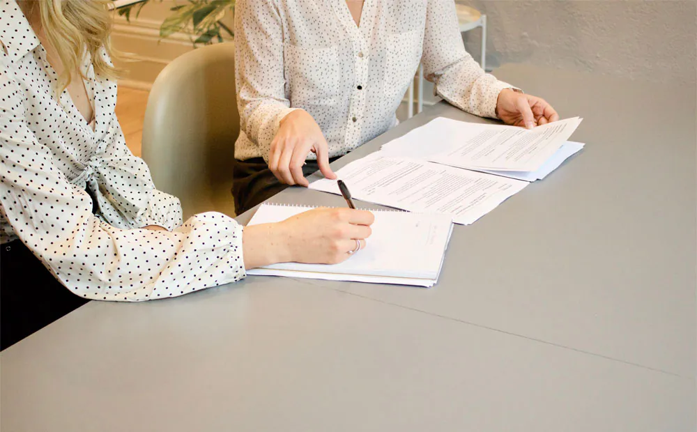 2 women doing documentation - quality of interaction observation sheets page new alzheimer's drug