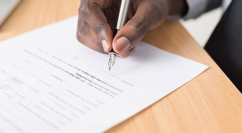 A man signing a contract - Terms and conditions page image