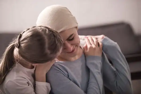 a child hugging and supporting sick mother in kerchief - End of Life EOL Care training course