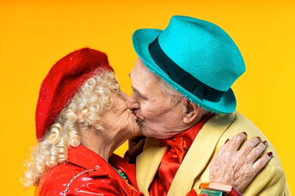 Beautiful senior old couple wearing fancy party clothes acting in studio on a colored background. Conceptual image about third age and seniority, old people feeling young inside - Sexuality Sensuality and Dementia Training Course