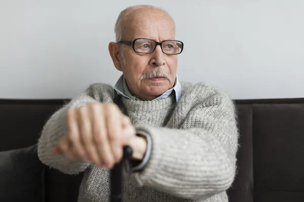 Old man with glasses and cane in a Nursing Home - picture for Distress Behaviours Refresher Training Course