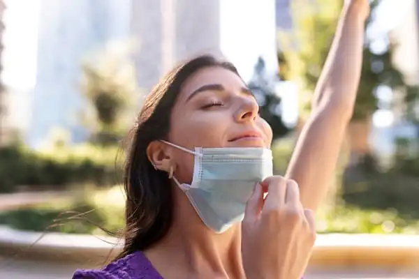 photo side view woman taking mask off - Infection Prevention and Control training course