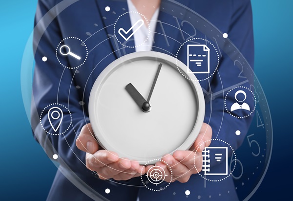 Young businesswoman holding clock on white background. Time management training course