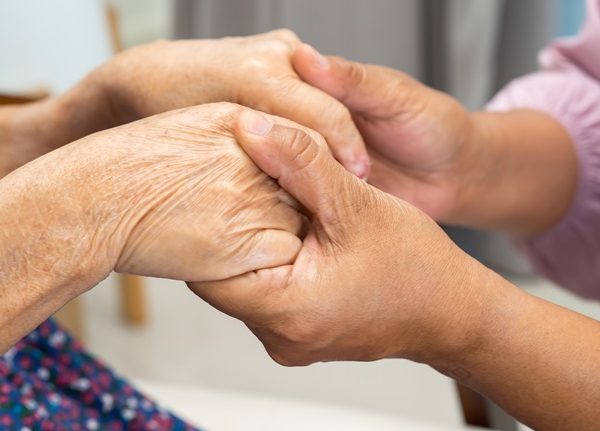 Carer holding hands of an elderly person. Picture for DoLS for Managers training course