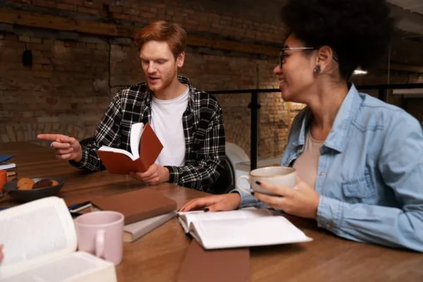 two people studying smiling learning environment man woman level 2 adult social care certificate