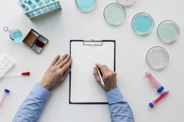 man writing notes on clipboard for in medical trial new alzheimer's drug will it be approved in the uk