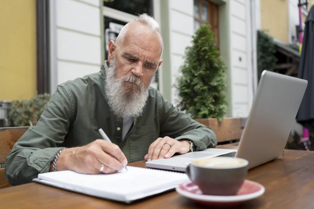 a man studying with laptop - level 2 adult social care certificate