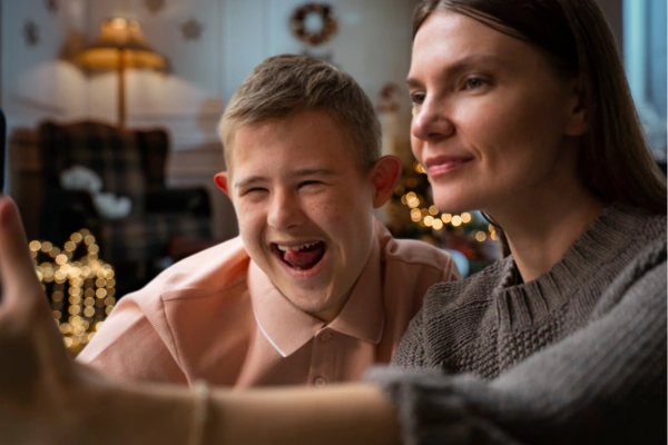 mother and son taking selfie Christmas background learning disabilities and autism at Christmas