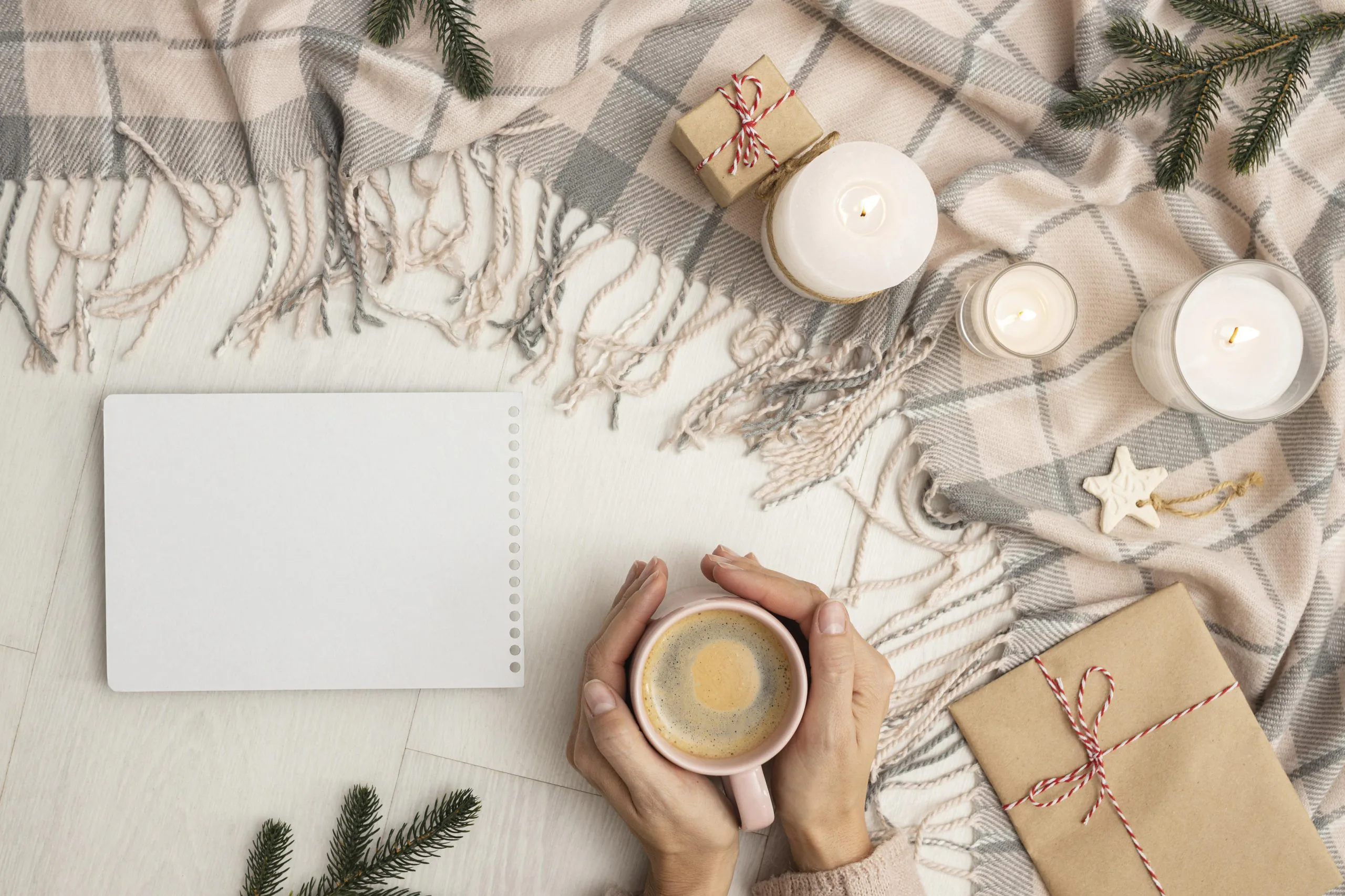 top-view-person-holding-mug-with-blanket-candles-scaled-managing-christmas-stress-cbt-techniques-for-registered-managers-in-adult-social-care